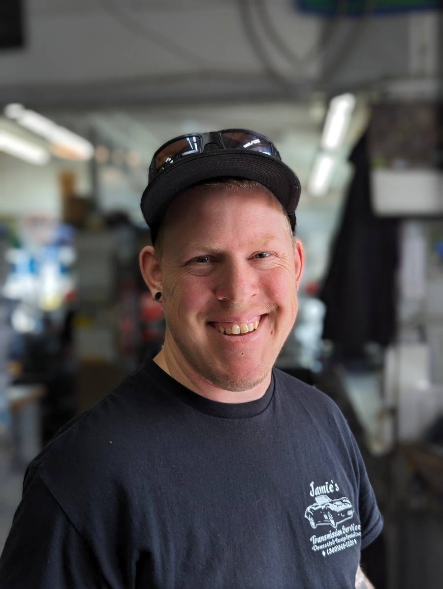 A smiling member of the Jamie's Transmission Service crew in the shop