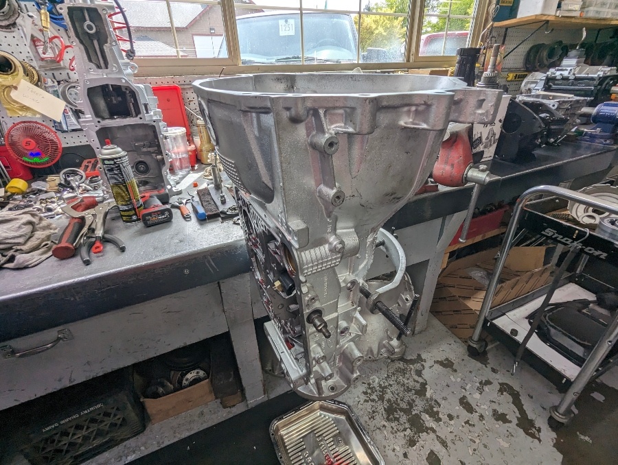 A cleaned transmission case mounted at the rebuild bench